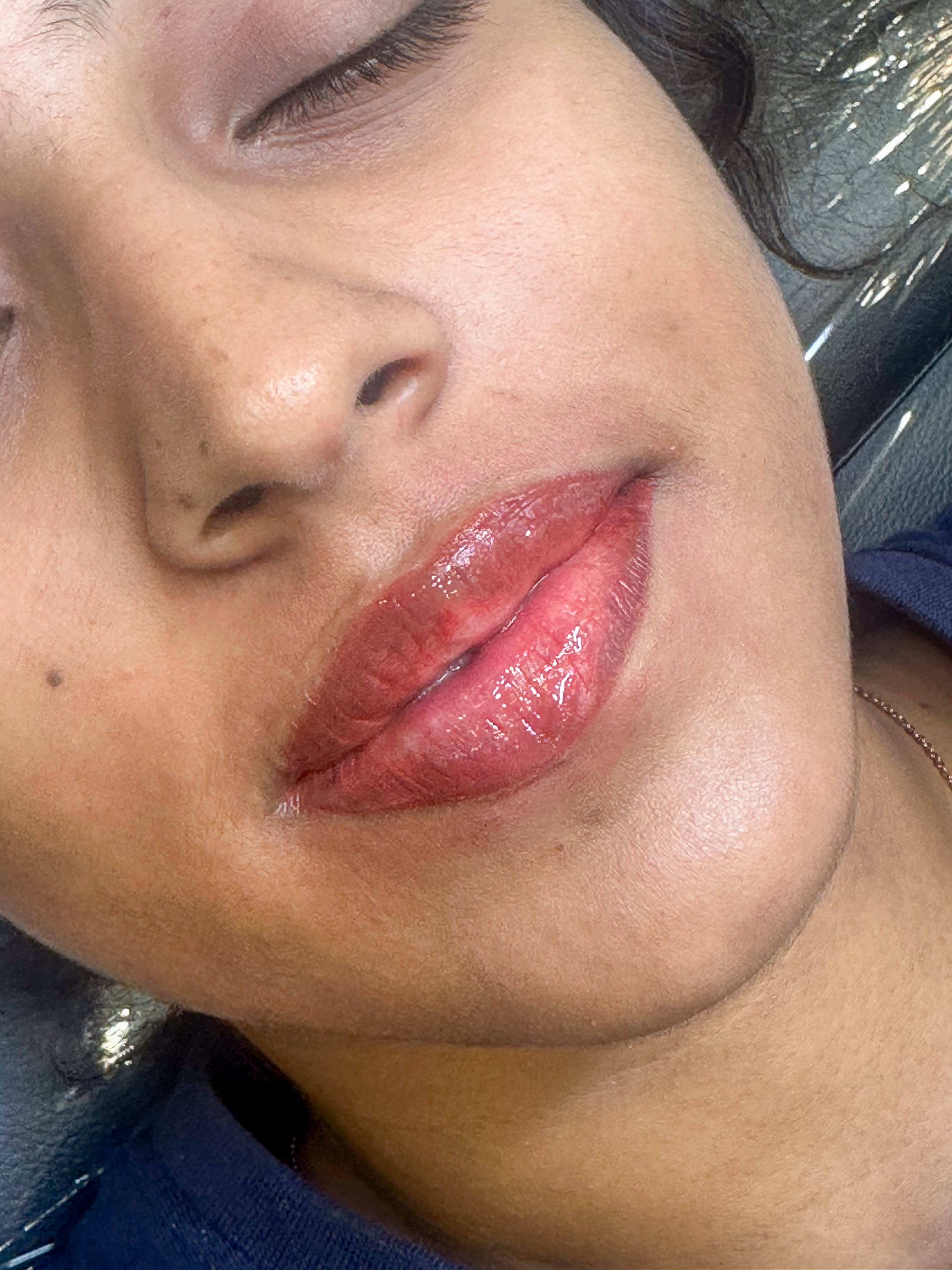 A happy client smiling and showing off her new eyebrows